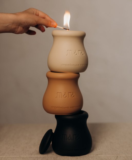Three stacked MAGA candle vessels in sand, clay and black