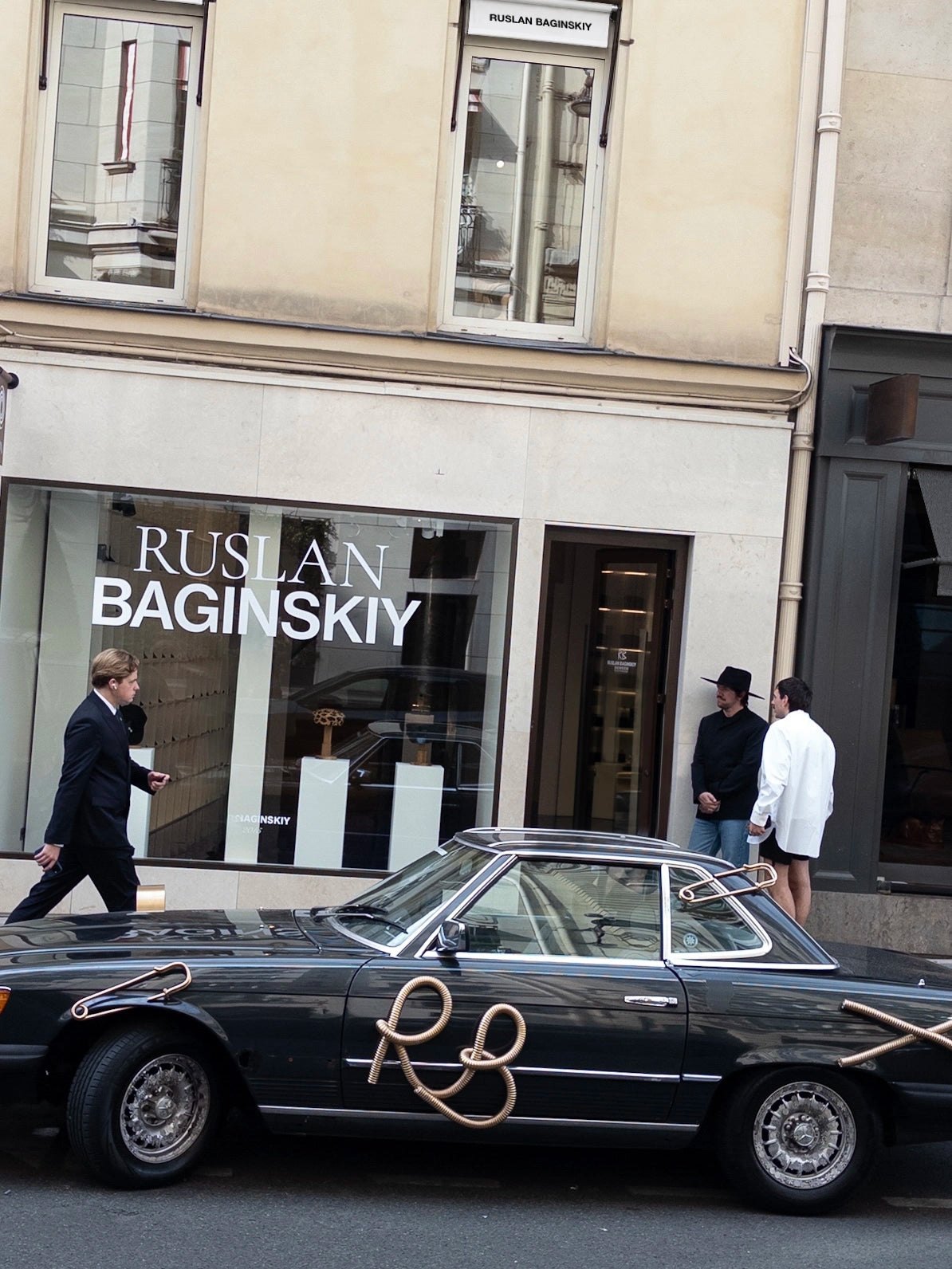 Ruslan Baginskiy storefront with a vintage car outside