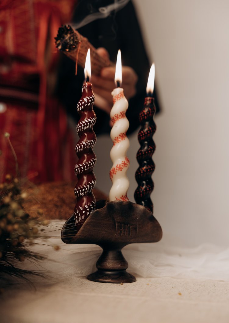 Twisted ritual candles in red, white and black